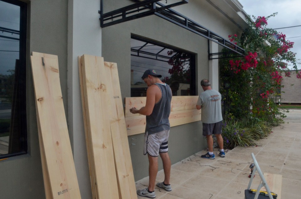 Floridians continued to board up their homes as Hurricane Matthew stalked the coast of the state in the early hours of Friday