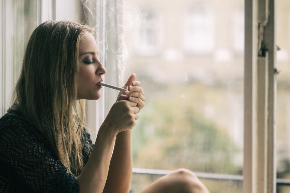 Young woman smoking cigarette