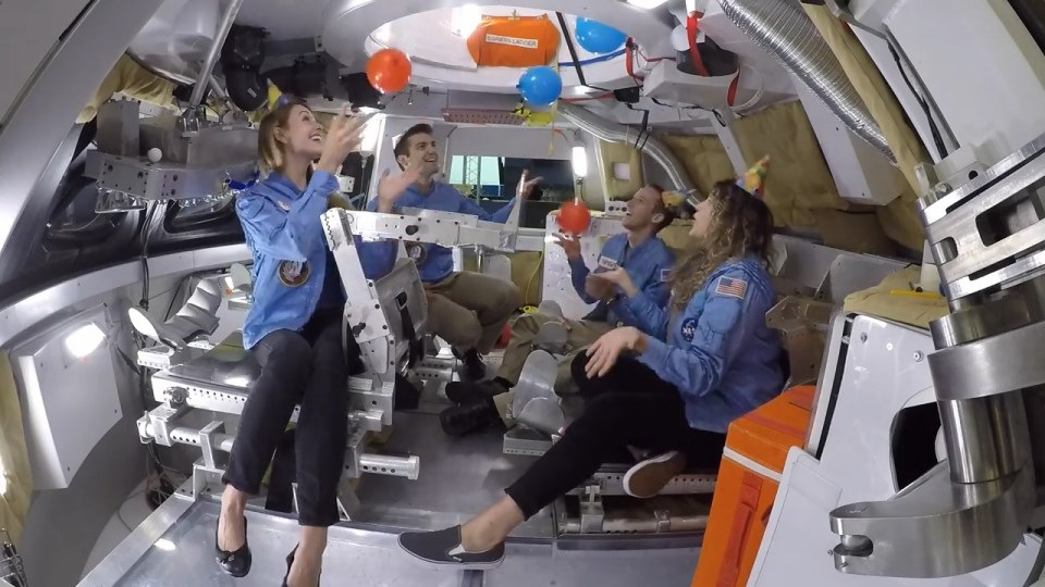  One section shows them with balloons and party streamers in a space capsule