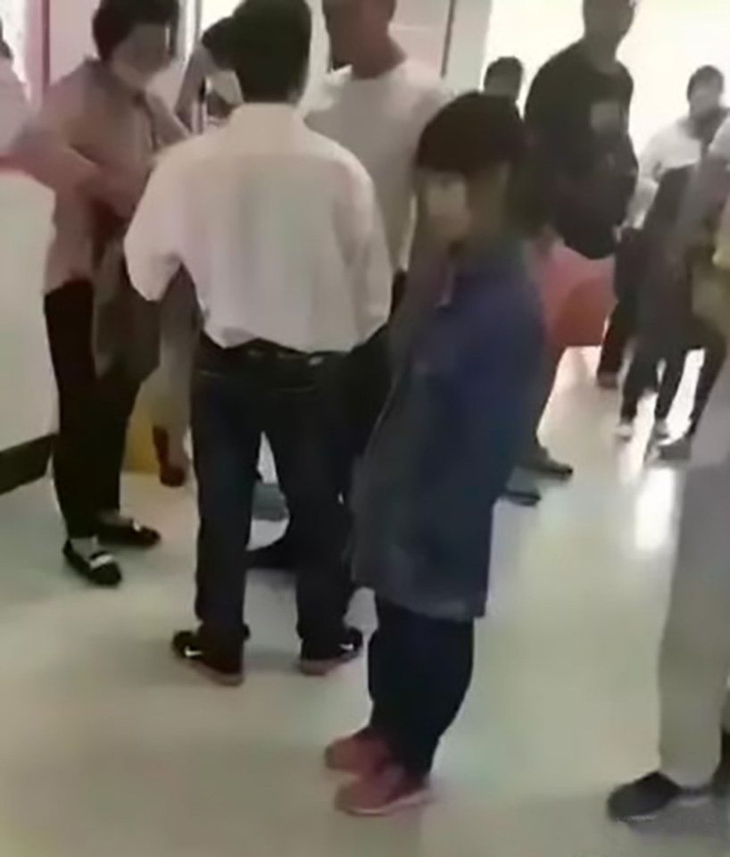  'Do your job' ... Girl, centre, with her 40-year-old 'husband', in the white shirt, as he argues with hospital staff