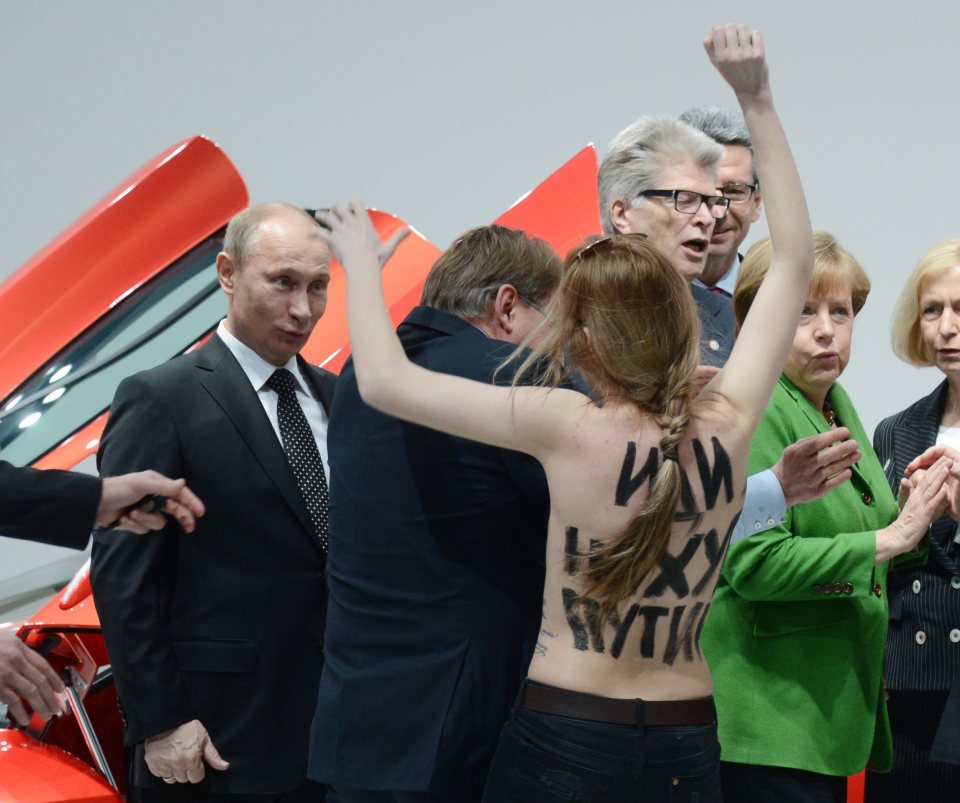  Putin caught off guard by a topless protester in Germany