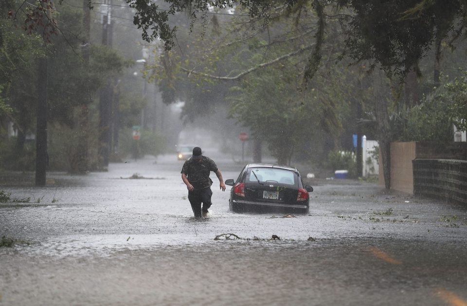  A man walks through a flooded street in St Augustine, Florida