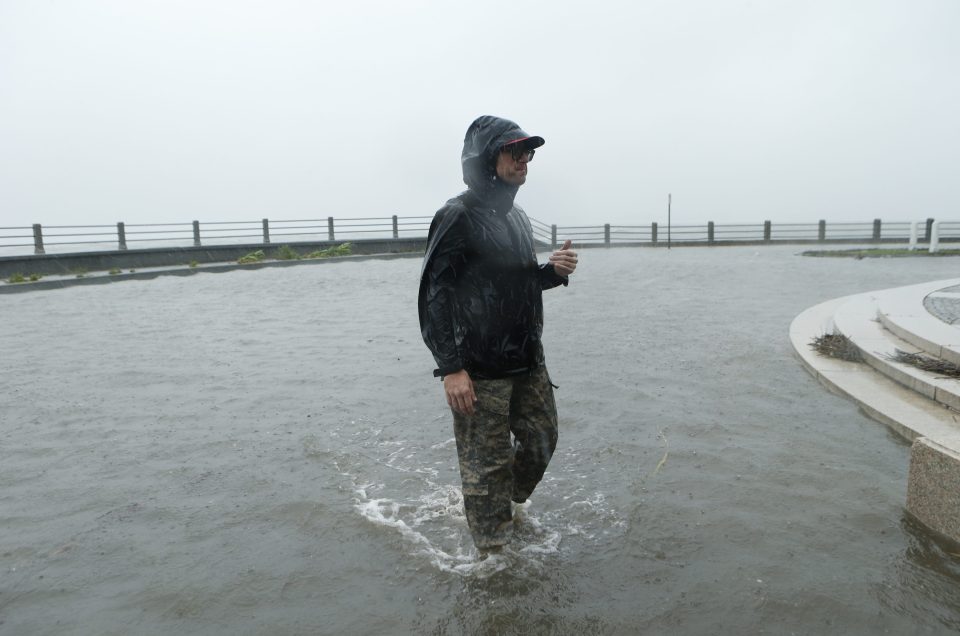 This man trudges through the floodwater in Charleston. The historic South Carolinan city had its sea walls breached