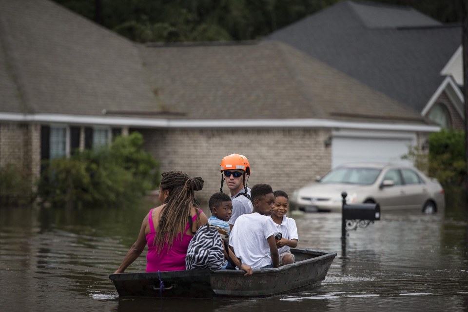  A member of the Pooler Fire Department uses a boat to move residents of homes on Tappan Zee Drive after Hurricane Matthew caused flooding in Pooler, Georgia