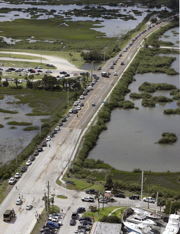  Residents of St. Augustine wait along side the road to get clearance to return to their homes after Hurricane Matthew on Saturday