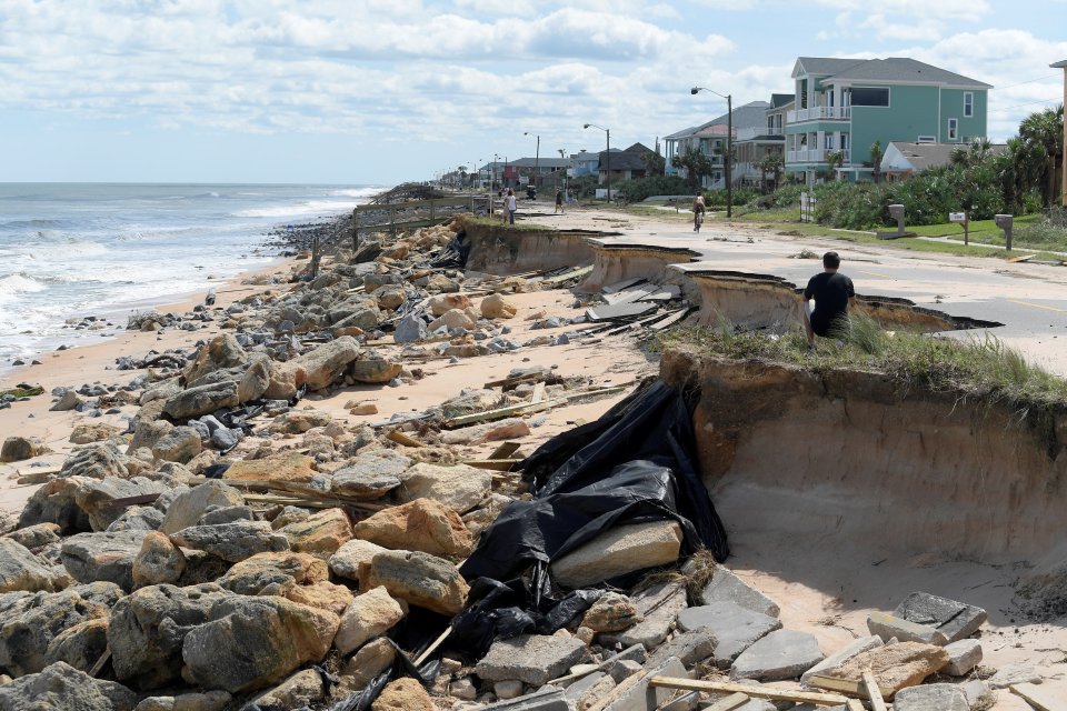  Onlookers view a washed out portion of State Highway A1A in the aftermath of Hurricane Matthew in Flagler Beach, Florida