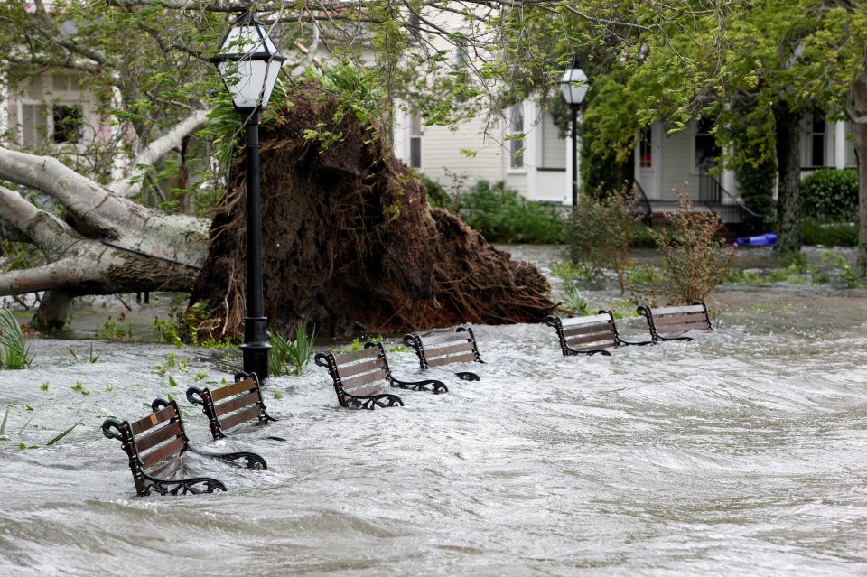  Storm surge and rainwater burst the banks of Colonial Lake and partially submerge park benches after Hurricane Matthew hit Charleston