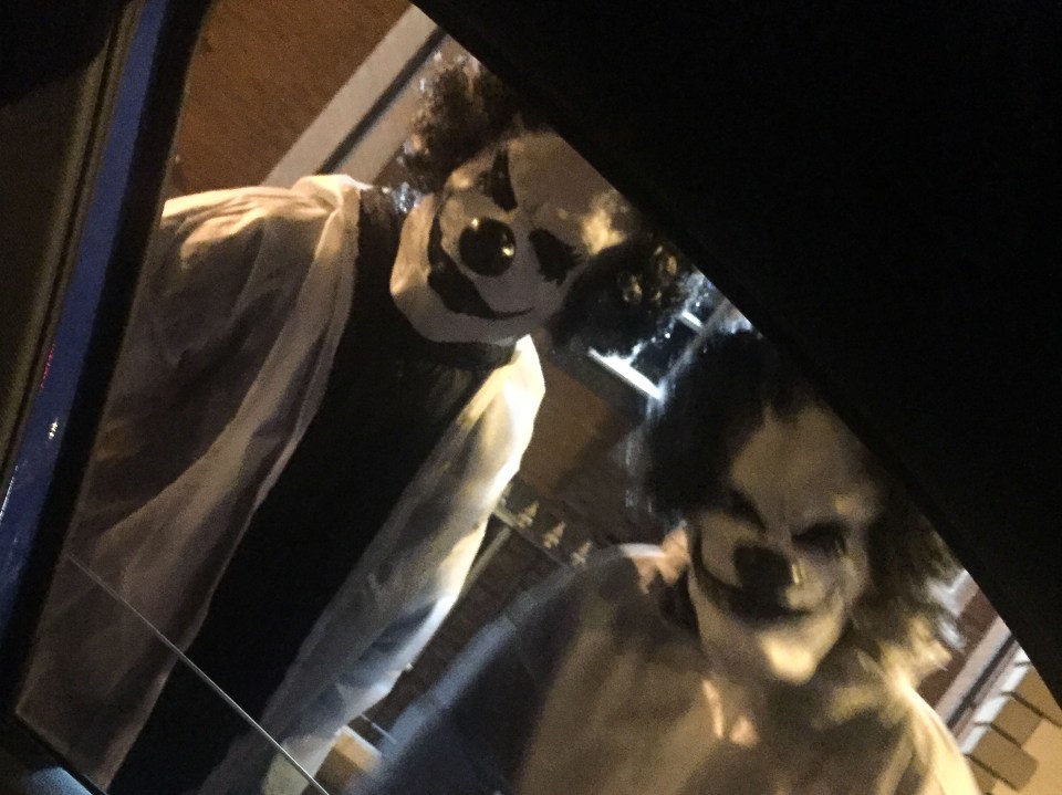 Two thugs dressed as clowns, pictured, wielded machetes and terrorised drivers who stopped at a set of traffic lights in Manchester last year