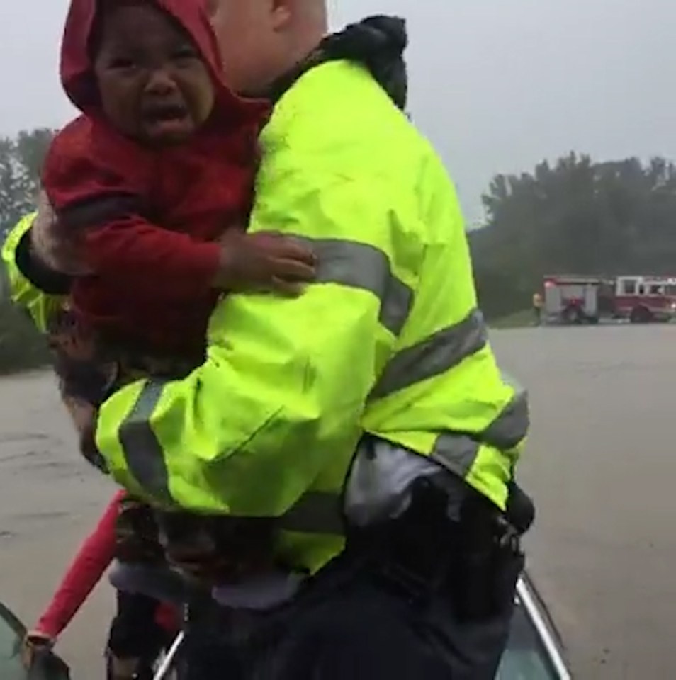 Rescuers took the child from his mother before helping her