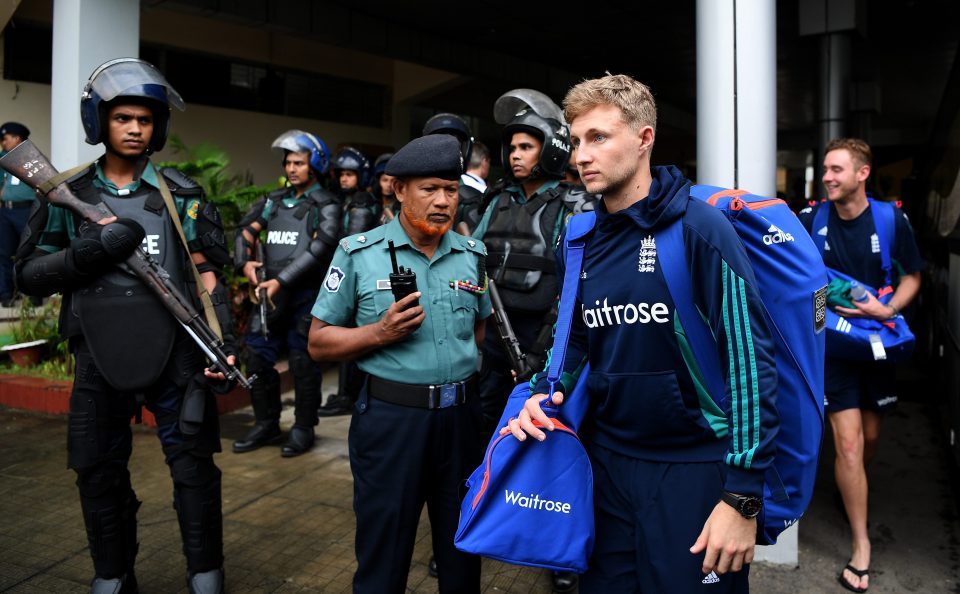  Joe Root walks on to the team bus under protection of heavy security