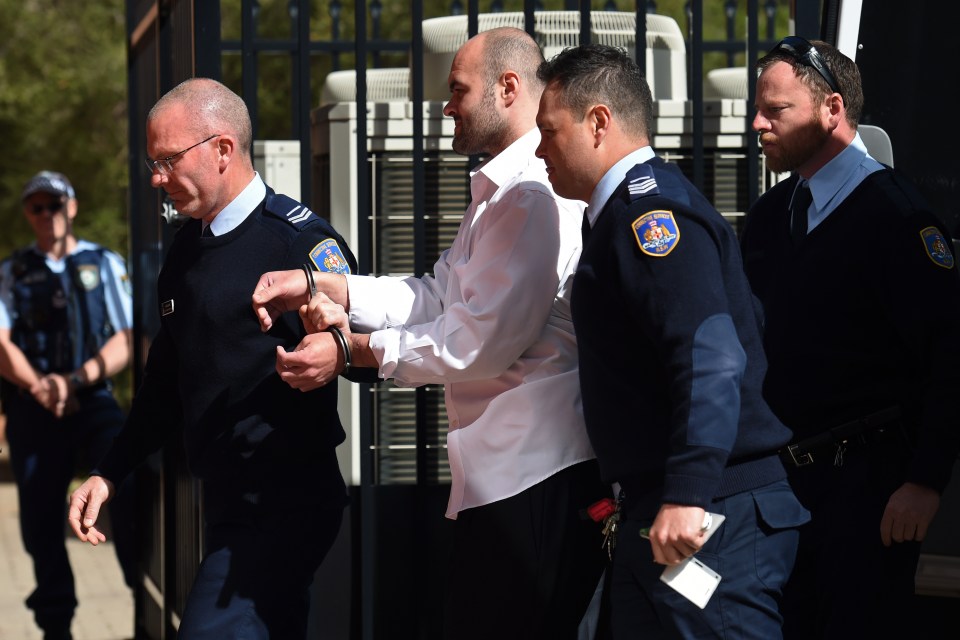  Vincent Stanford (centre) is escorted into court