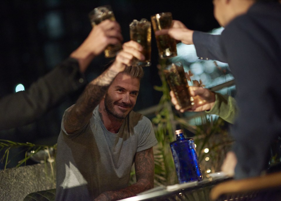  David Beckham raises a glass filming the scenes for the sexy new advert