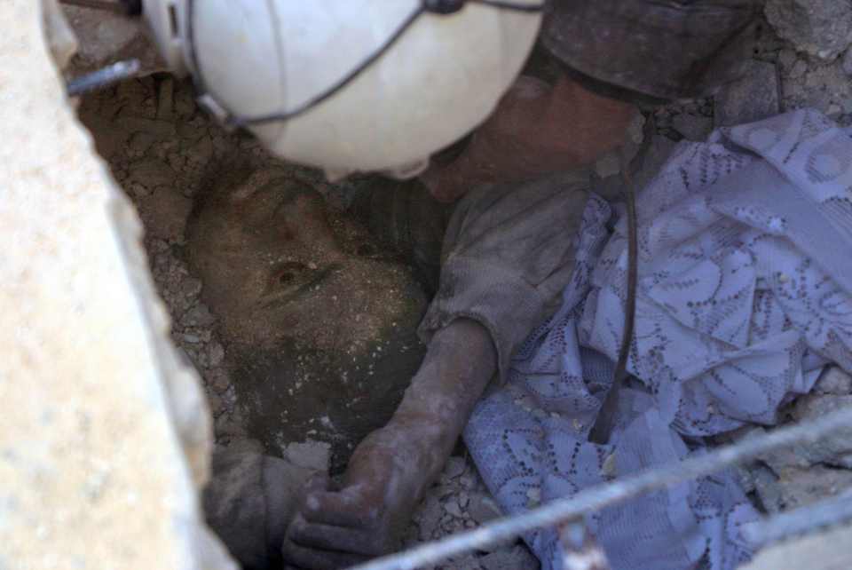  A young Syrian boy being pulled from the rubble following a airstrike in Aleppo