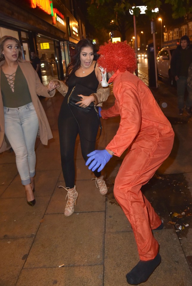  The clown lunges at Chloe and grabs her around the back