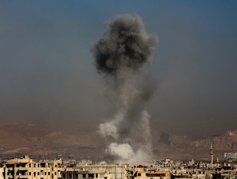  Smoke rises over Damascus after an airstrike led by the regime of President Assad