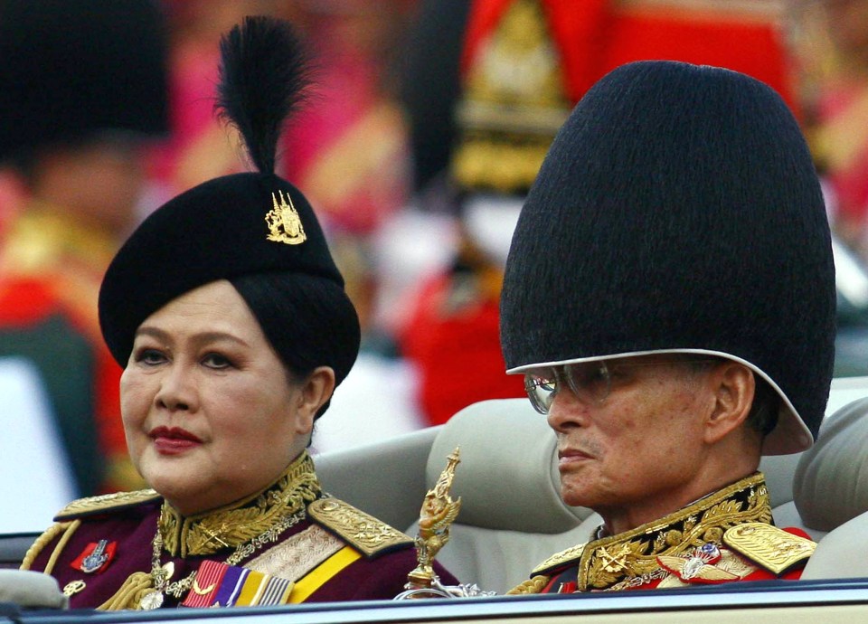  The Thai monarch reviewing the honor guard next to Queen Sirikit as part of celebrations to commemorate his 79th birthday in 2006