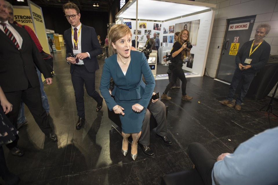  Nicola Sturgeon appears to have had her bum pinched by her husband as they joke around at the SNP conference