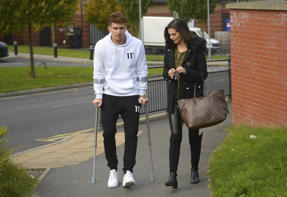  Emma wrapped up in a black jacket and accessorised with a designer handbag