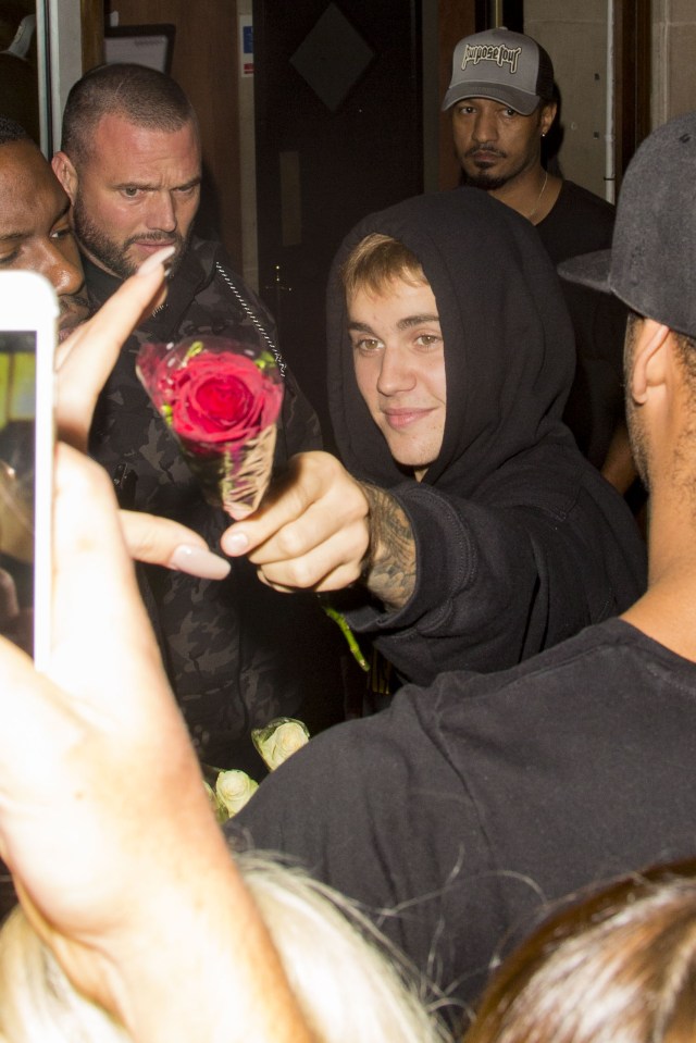  Justin Bieber gave adoring fans flowers as they waited out in the cold for him