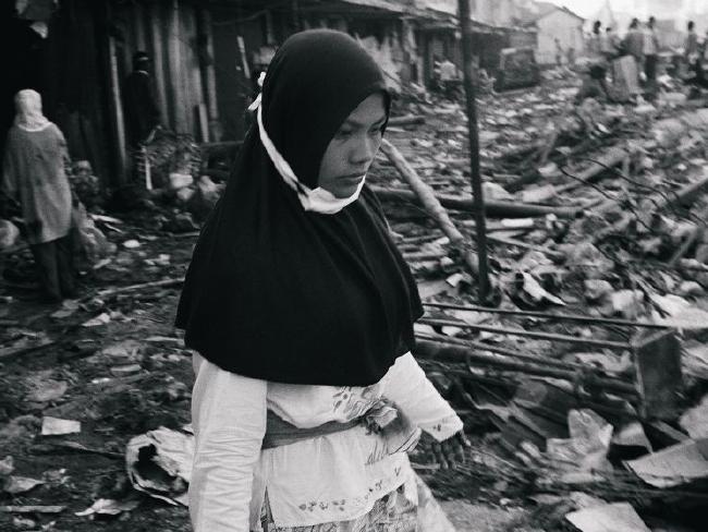  A woman wades through the rubble at Banda Aceh, Indonesia, following the tsunami in 2005