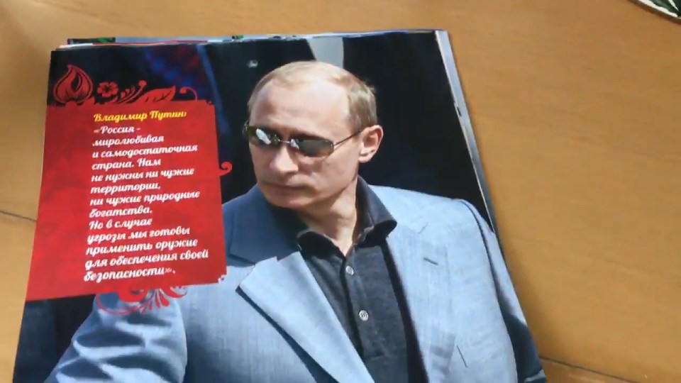  Putin revisits his KGB days in a pair of dark glasses and a sharp suit for October