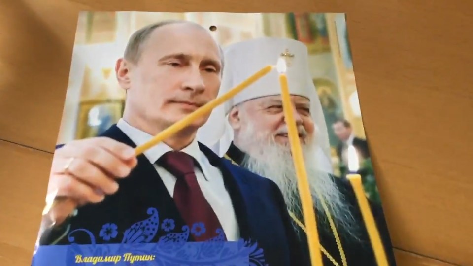  And he shows off his spiritual side by lighting a candle alongside a group of Orthodox bishops