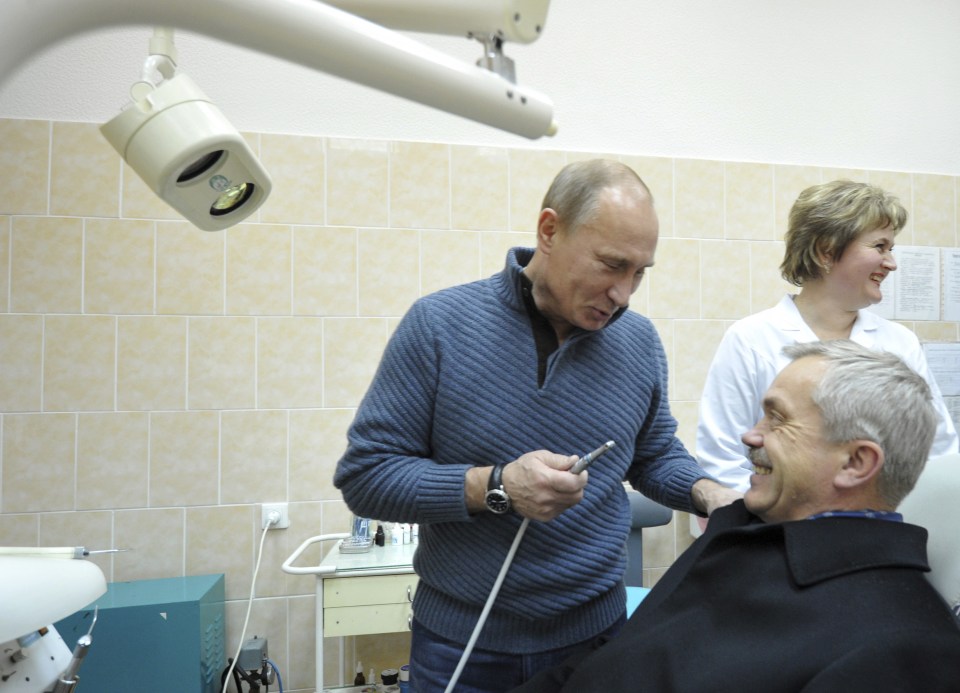  Putin holds a dental borer as he jokes with Governor of the Belgorod Region Yevgeny Savchenko in 2011