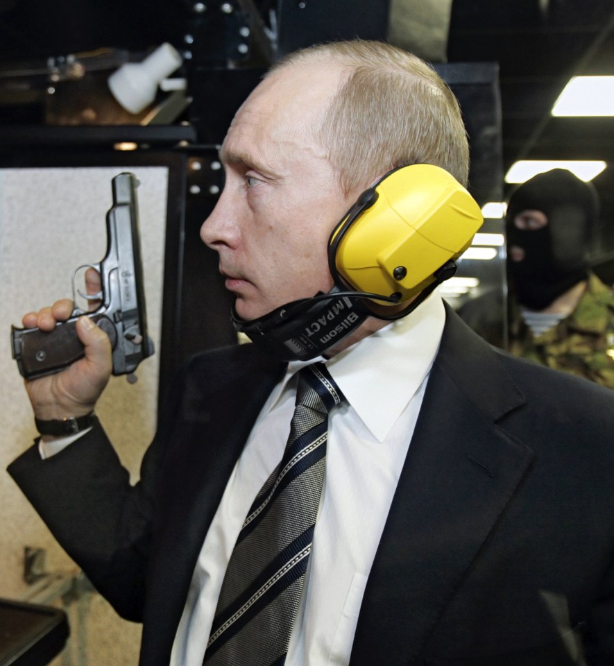  Putin stands with a pistol at the shooting range he officially opened in 2006