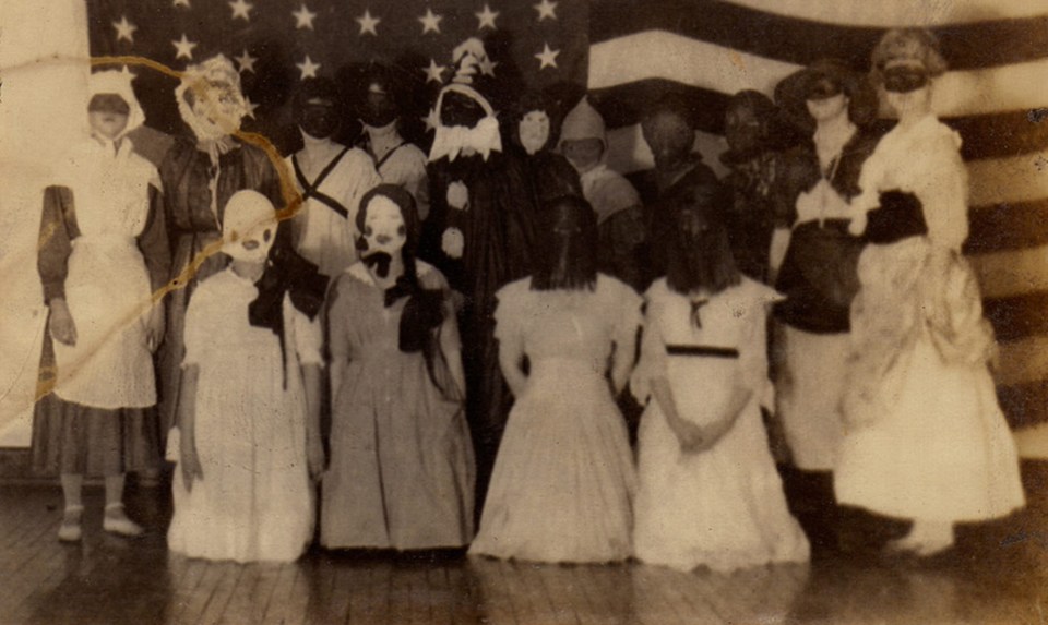  A group of schoolchildren pose in front of the America flag