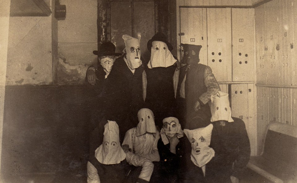  A group of men pose in creepy masks