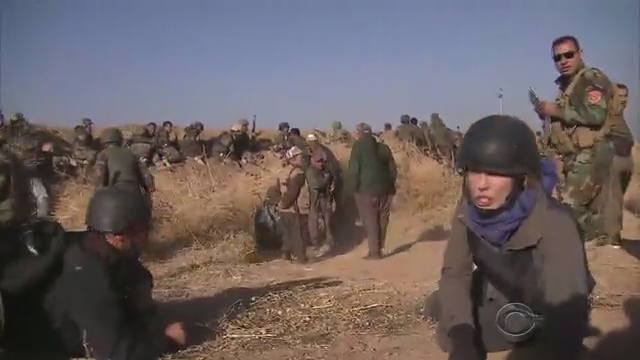  The peshmerga fighter stares at the war reporter as he walks past her shot