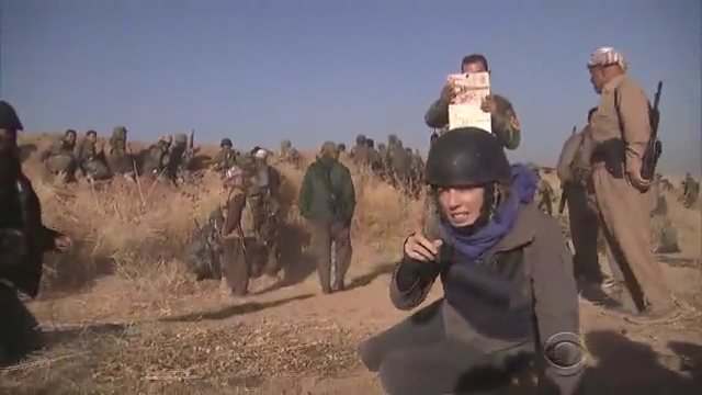  With a grin on his face, he takes a photograph of the CBS report