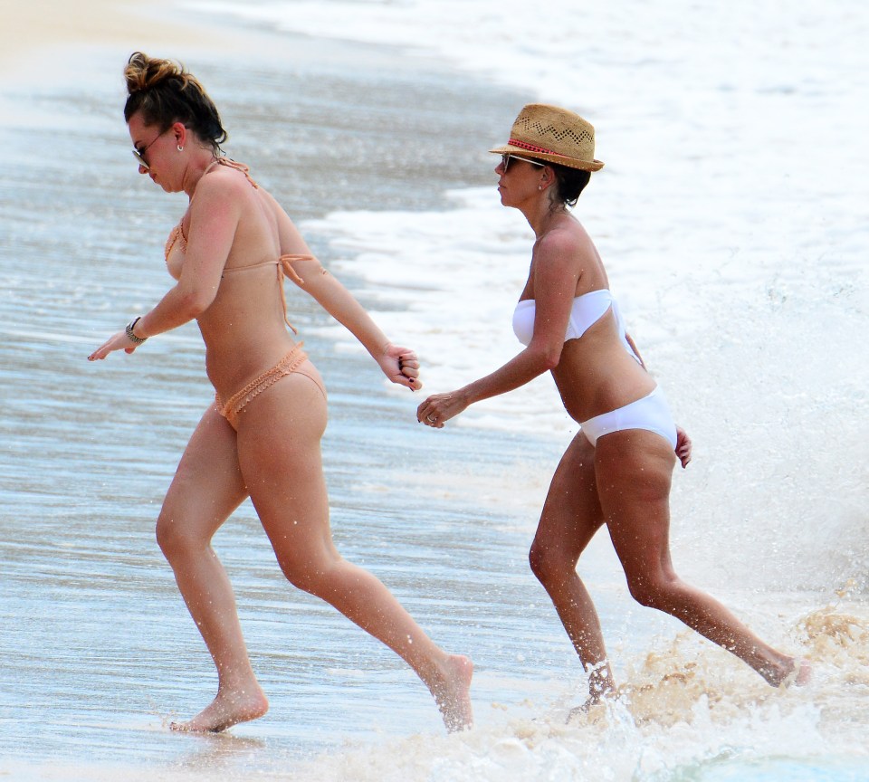  Chloe and Lainya Shearer make their way out of the sea after taking a swim