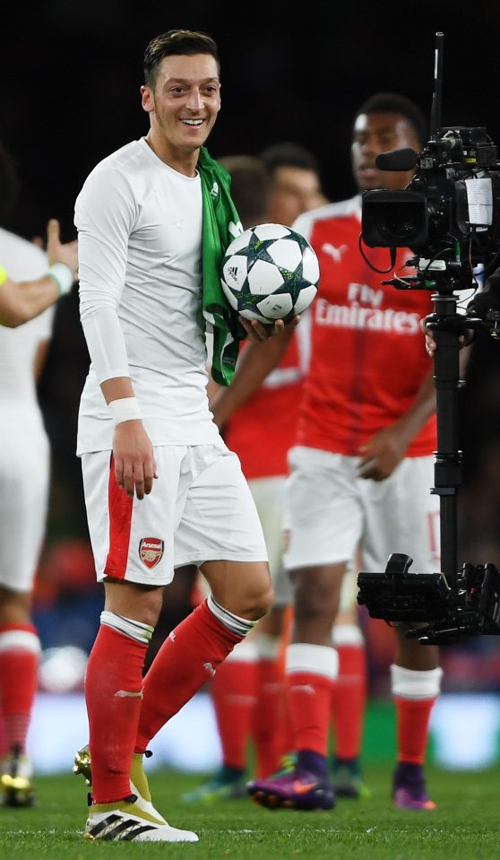  Ozil walks off with the match-ball after his three quality finishes laced a big win