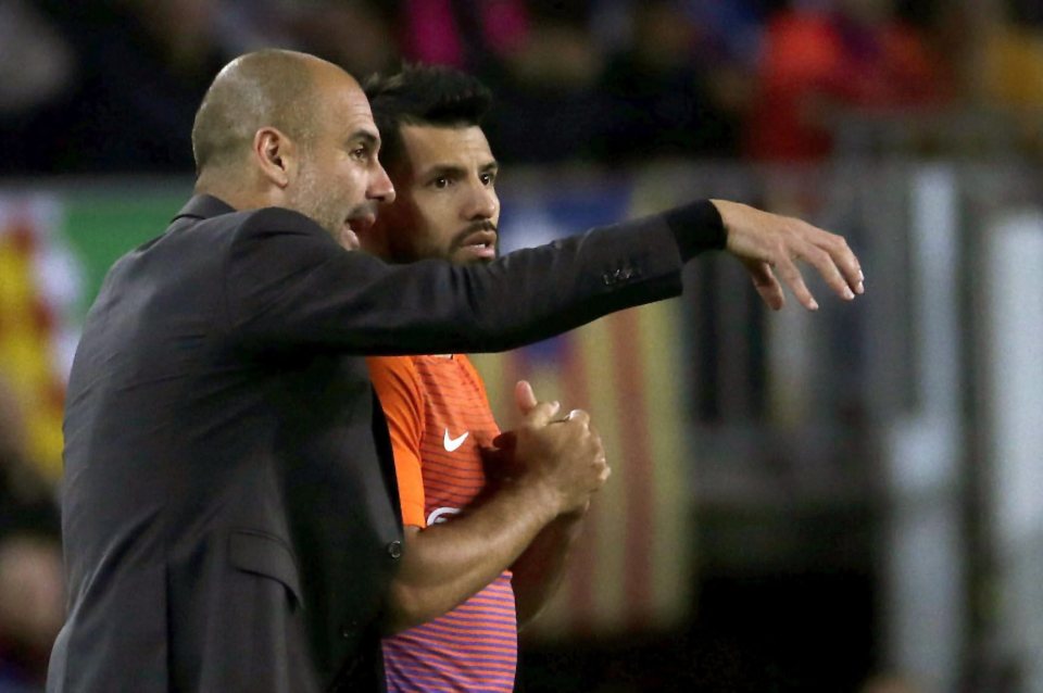  Pep Guardiola gives instructions to Man City striker and substitute Sergio Aguero