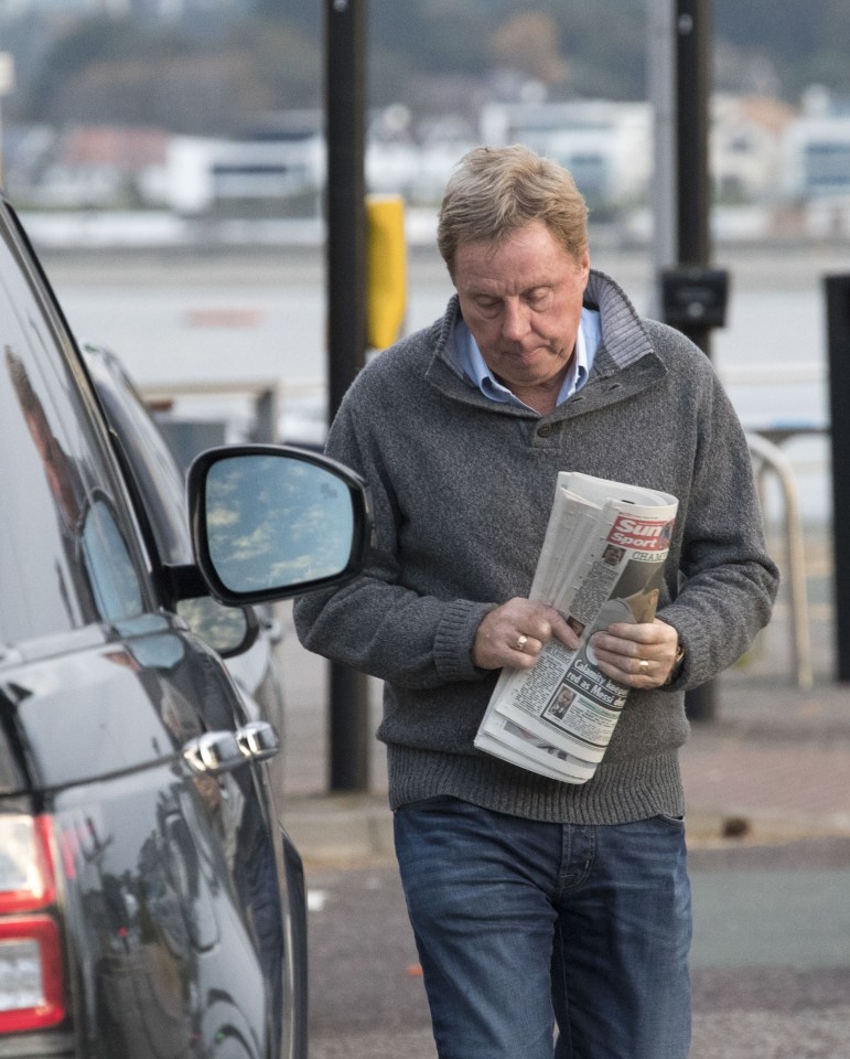  Harry Redknapp carries a copy of The Sun