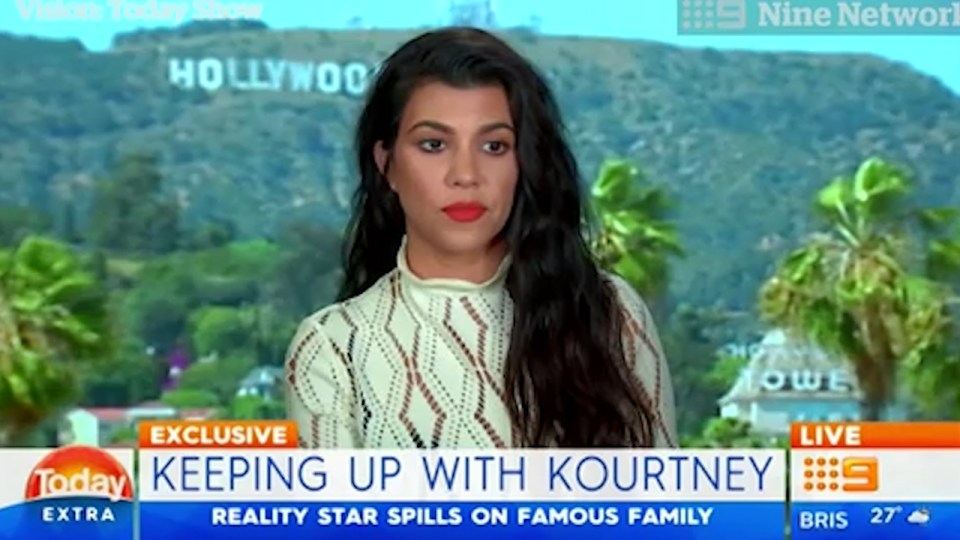  Kourtney blanks an Australian newscaster