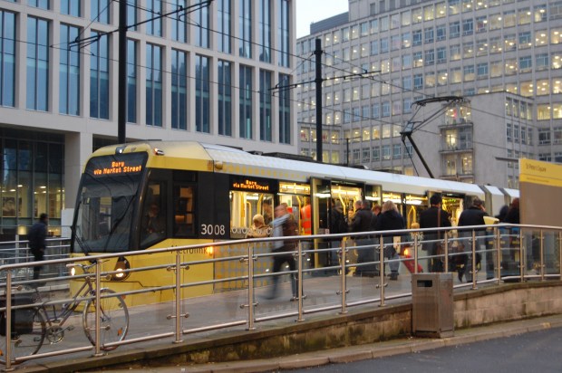 A Metrolink tram travelling through Manchester city centre