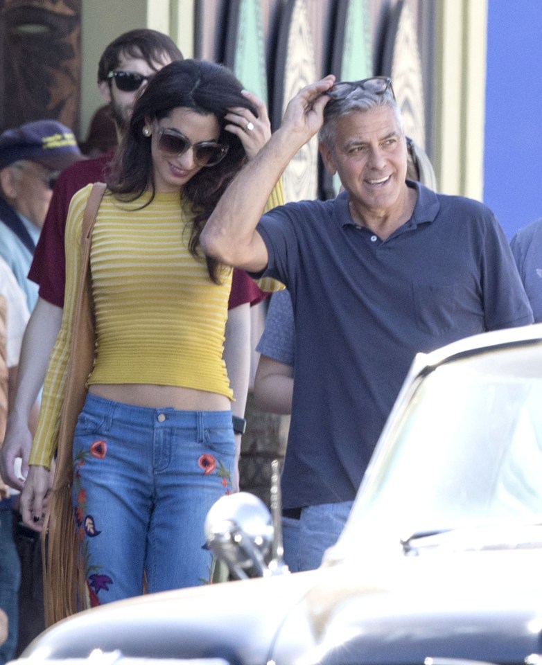 Amal carried a tassled handbag over her shoulder as they walked along