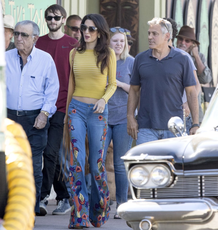 Meanwhile Amal wore a pair of striking flared jeans complete with colourful floral detail down each side