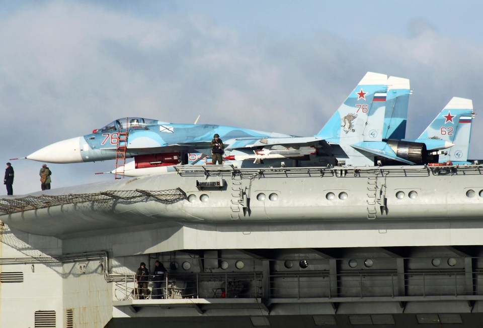  Machine gun-toting marines could be seen guarding the ship's flight deck as it passed Dover today