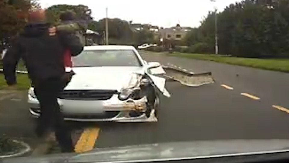  The Mercedes has been completely smashed up as the dad goes over to check on the driver and explain what nearly happened