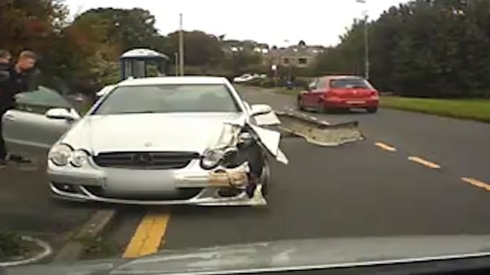  The dad carrying his toddler opens the driver door after the Mercedes came to a halt