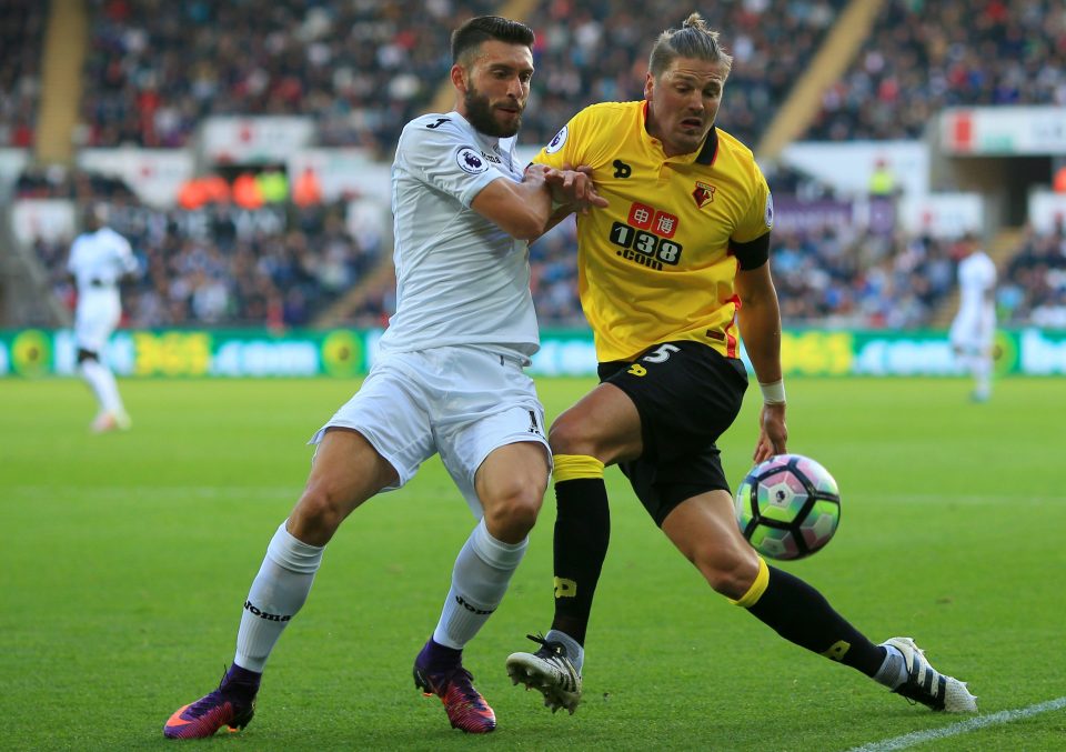  Borja Gonzalez tussles with Watford star Sebastian Prodl during a tight first half