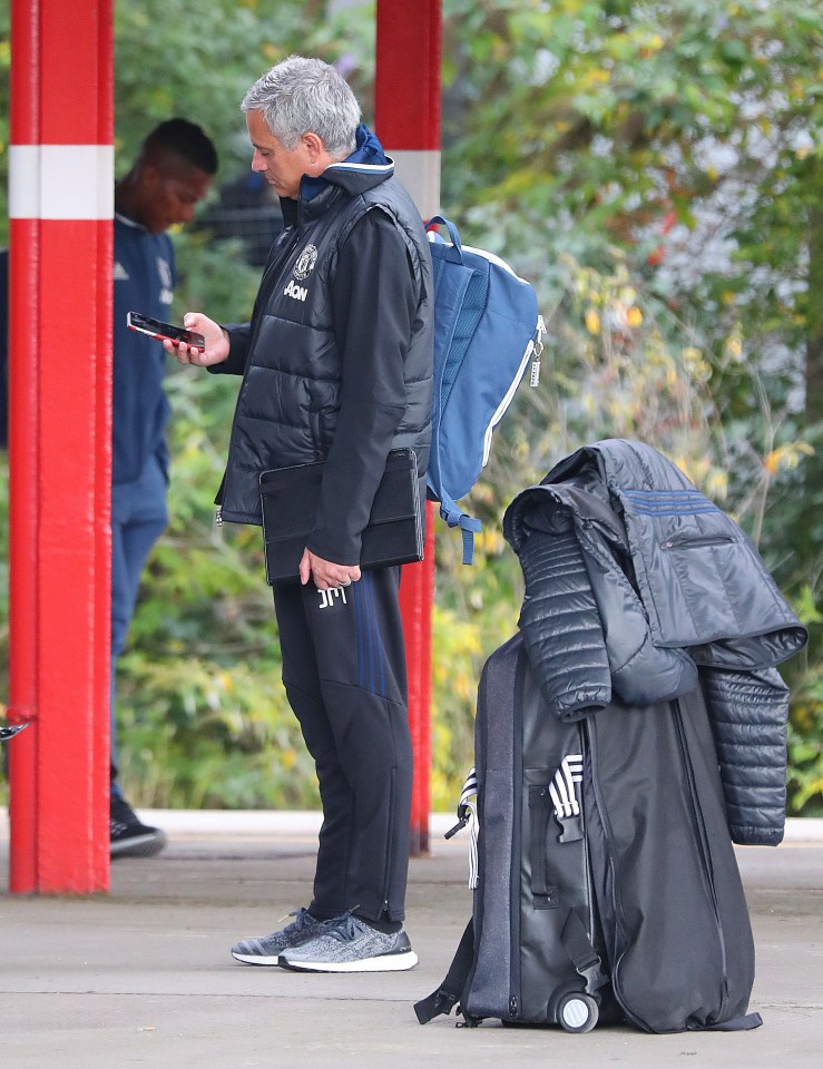  Jose Mourinho was focused on his phone at Stockport station