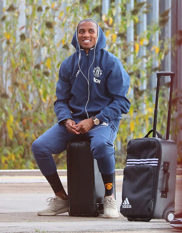  Ashley Young looked happy as he sat on his luggage