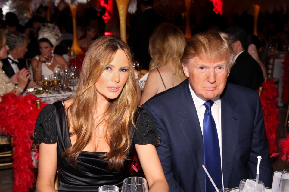  Melania Trump and Donald as they sit together at a table during the 16th annual 'Lady in Red' gala in 2009