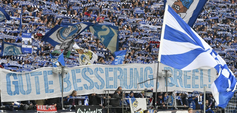  Schalke fans hold a banner with a message of support for injured Breel Embolo