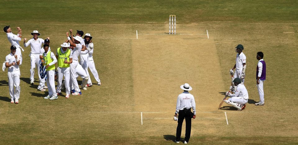  England players celebrate in a huddle as the Bangladesh batsmen slump to the ground in Chittagong