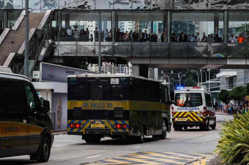  A van carrying Jutting leaves the High Court escorted by a police convoy in Hong Kong